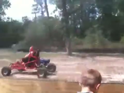 Red SpiderCarts Arachnid go kart on a dirt lot
