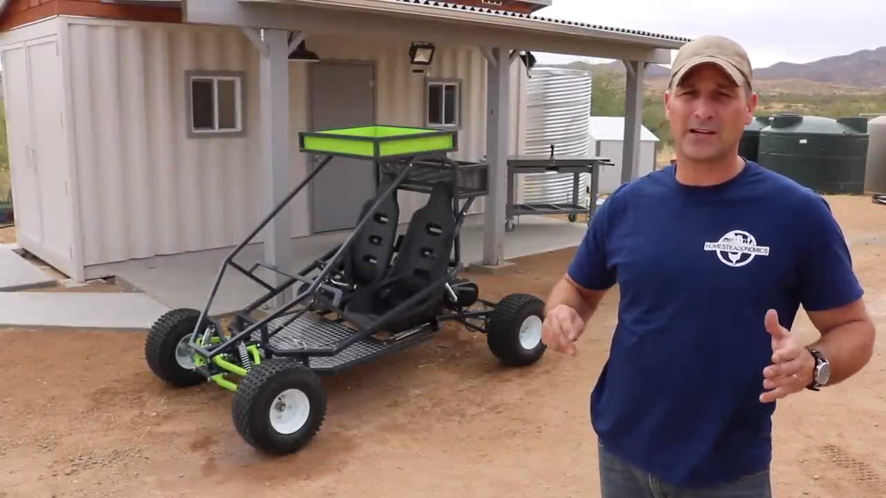 Finished off-road go kart with the builder standing beside it