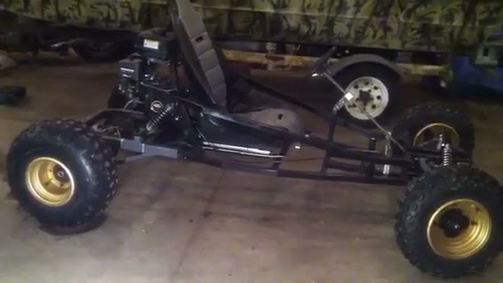 Black SpiderCarts Arachnid go kart on gold ATV wheels