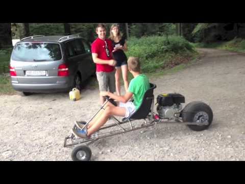 A SpiderCarts off-road single-seater kart on a forest gravel road