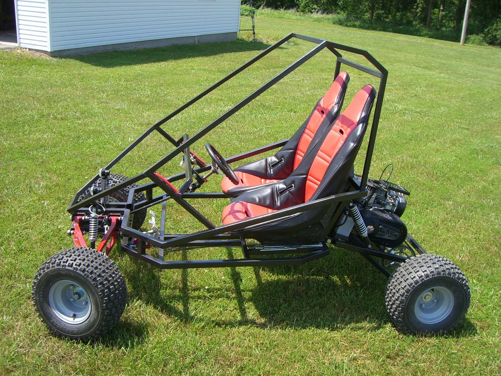 Grand Daddy two-seat off-road go kart, front three-quarter view on grass