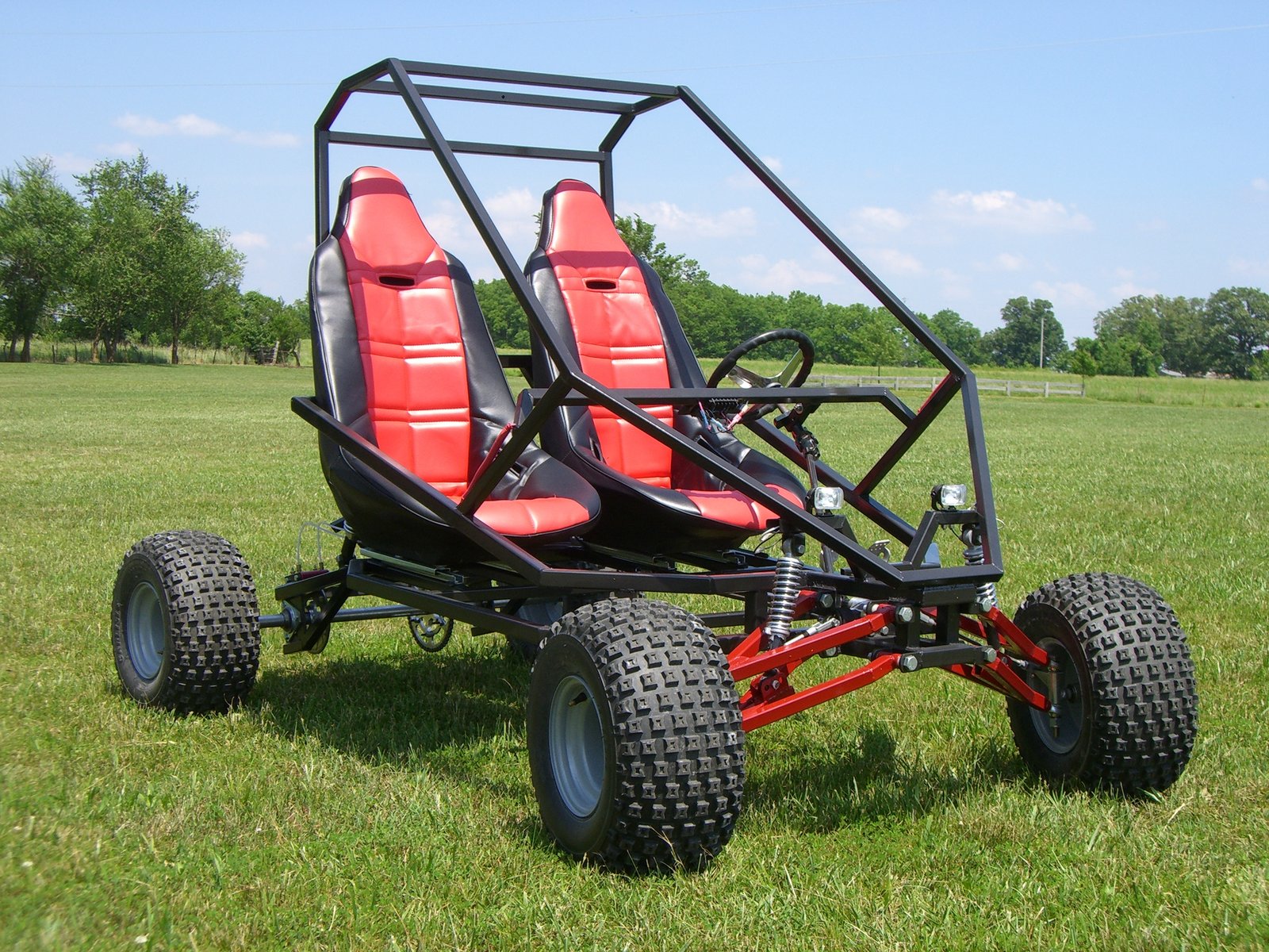 Finished GrandDaddy two-seat buggy with red bucket seats, on grass